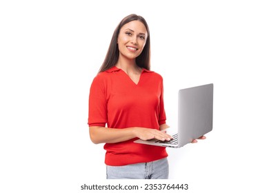 pretty caucasian woman with black hair dressed with a red v-neck blouse holding a laptop to work in the office