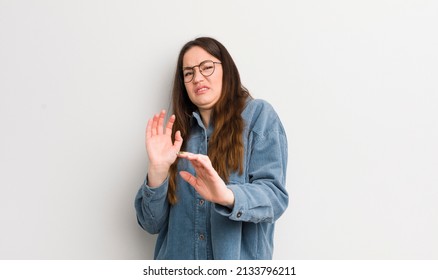 Pretty Caucasian Woman Feeling Disgusted And Nauseous, Backing Away From Something Nasty, Smelly Or Stinky, Saying Yuck