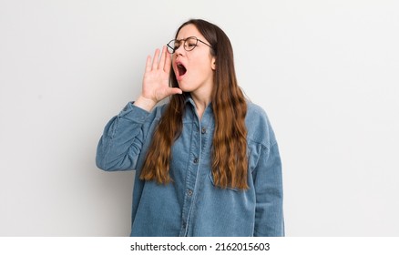 Pretty Caucasian Woman Yelling Loudly And Angrily To Copy Space On The Side, With Hand Next To Mouth