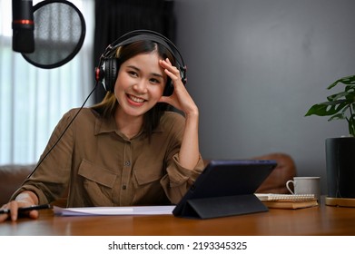 Pretty And Charming Young Asian Female Freelance Podcaster Running Her Online Show At Home Studio. Broadcasting And Podcasting Concept