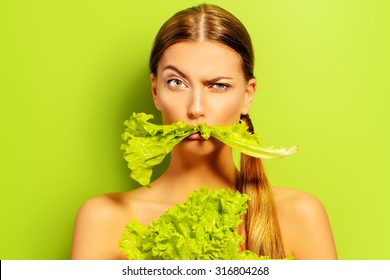 Pretty cheerful young woman posing with fresh green lettuce leaves. Healthy eating concept. Dieting. - Shutterstock ID 316804268