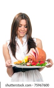 Pretty Chef Woman Holding A Plate In Hand With Turkey Meat Ham With Lettuce, Asparagus, Carrot, Strawberry And Lemon On A White Background