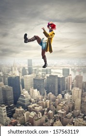 Pretty Clown Walking On A Tightrope Above The City