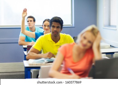 Pretty College Student Raising Her Hand In Lecture Room