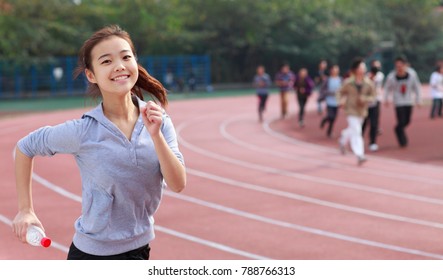 Pretty College Student Running In The Campus