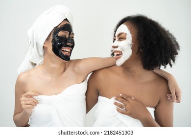 Pretty couple Asian African woman friend smile and fun together with masking face spa cosmetic as diversity racial LGBT - Powered by Shutterstock