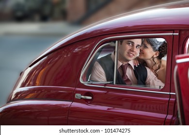 Pretty Couple In The Back Seat Of The Vintage Car.