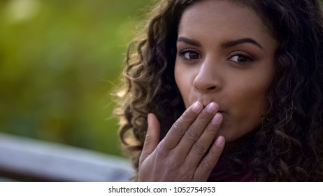 Pretty curly-haired girl sending air kisses for camera, happiness, emotions - Shutterstock ID 1052754953