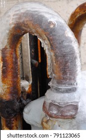 Pretty Curved Rusty Metal Pipe Encased In Ice Enveloped Gas Meter Winter