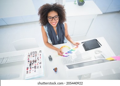 Pretty designer working at her desk in her office