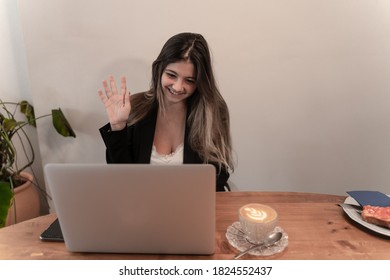 Pretty Elegant Businesswoman Waving While Smiling On Video Call Or Virtual Meeting At Breakfast And Coffee Time