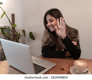 Pretty Elegant Businesswoman Waving While Smiling On Video Call Or Virtual Meeting At Breakfast And Coffee Time