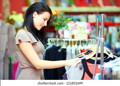 Pretty Elegant Woman Shopping In Clothes Store