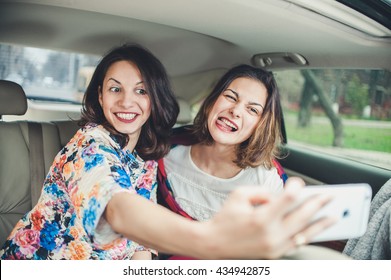 Pretty European Girls 25-30 Years Old In The Car Make Photo On Mobile Phone