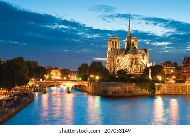Pretty evening illuminations of the stunning Notre-Dame Cathedral (1163) and parisian apartments along the banks of the river Siene, Paris.
