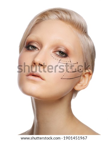 Pretty fashionable white blonde girl with perforation lines on face, plastic surgery concept, close up portrait