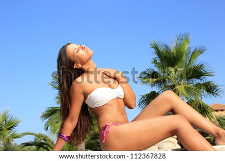 Pretty female in bikini on the beach