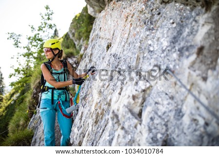 Similar – Image, Stock Photo Rock climber clinging to a cliff.