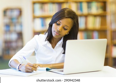 pretty female college student studying in library