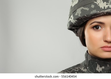 Pretty Female Soldier On Grey Background, Closeup