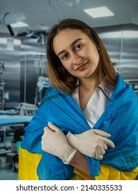 Pretty Female Surgeon Or Nurse Poses And Supports Peoples In The Ukrainian Flag During The War With Russia. Global Support For Ukraine