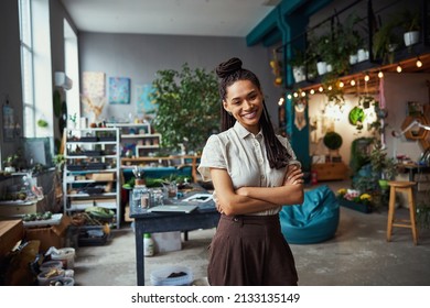 Pretty Florist With Cornrows Looking In Front Of Her