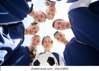 Pretty football players smiling at camera on a sunny day - Powered by Shutterstock