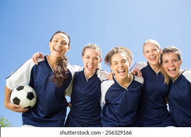 Pretty football players smiling at camera on a sunny day - Powered by Shutterstock