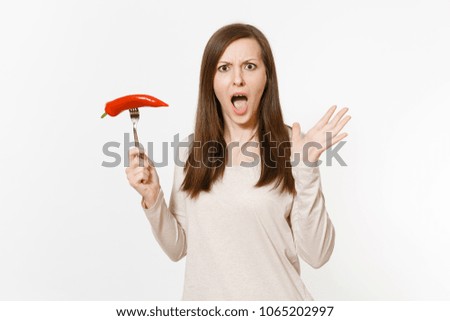Pretty fun vegan woman holds in hand red hot chili pepper on fork isolated on white background. Proper nutrition, vegetarian food, healthy lifestyle, vegetable concept. Advertising area to copy space