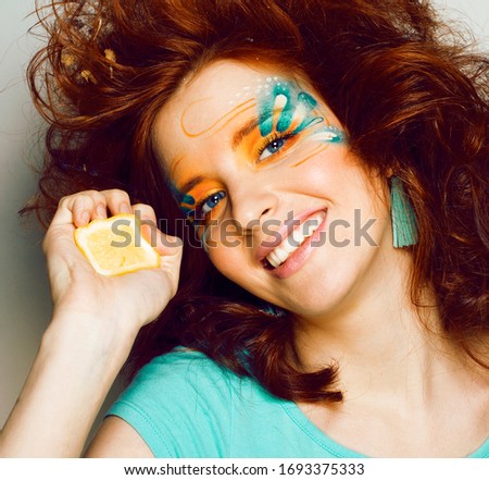 pretty funny girl with art creative make up, closeup floral print on face, beauty concept
