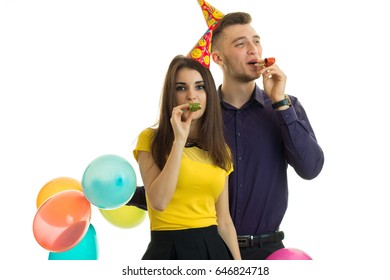 pretty funny girl and the guy holding balloons and blow horns close-up