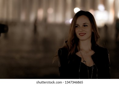 Pretty Girl With Adorable Eyes Watching On Camera. Amazing Model Walking In The City At Night And Making Photos