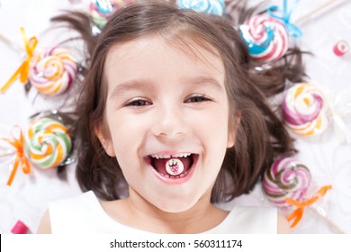 Pretty Girl Among The Sweets, Candies And Lollipops.
Funny Child With Candy Lollipop, Happy Little Girl Eating Big Sugar Lollipop, Kid Eat Sweets. Surprised Child With Candy. 