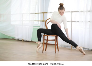 Pretty girl ballet dancer in a room practicing indoor