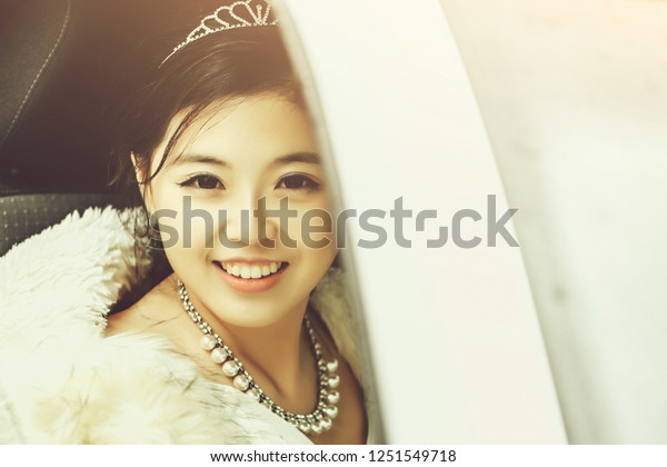Pretty girl chinese smiling happy bride young\
asian woman smiles through car\
window