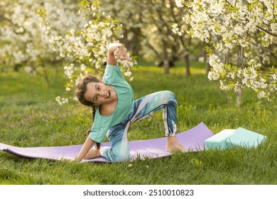 pretty girl doing yoga exercises, little girl doing yoga exercises in the garden. - Powered by Shutterstock