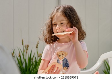 Pretty Girl Eating Pita In The Backyard