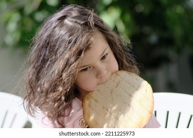 A Pretty Girl Eating Pita In The Backyard