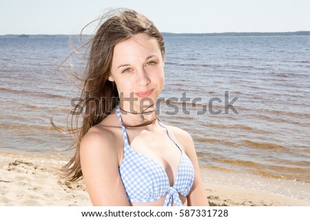 Pretty girl, happy on the beach in a swimming suit