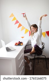 Pretty Girl Have Online Birthday Party. Laptop, Decorations, Gifts, Fruits And Cocktail On The Table. 