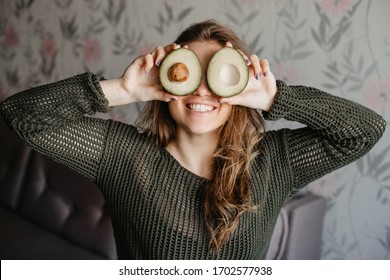 Pretty Girl Holding A Cut Avacado