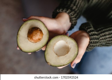 Pretty Girl Holding A Cut Avacado