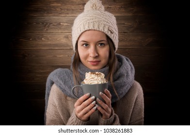 Pretty Girl Is Holding  A Hot Chocolate. Winter Scene. Scarf And Woolen Cap