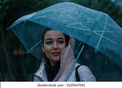 Pretty Girl Holding Umbrella And Strolling On Rainy Autumn Day. Photo Looks Like Film Frame Or Movie Screenshot In Cold Colors