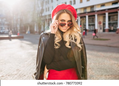 Pretty Girl With Joyful Face Expression Feeling Good In Sunlight. Surprised Lovely Young Woman Dressed Red Skirt And Red Hat. Body Language, Happy Emotions, Friendly Smile