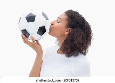 Pretty girl kissing her football on white background