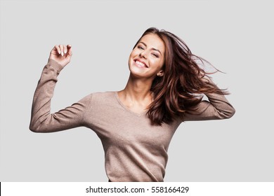 Pretty girl with long hair laughing, dancing and enjoying life