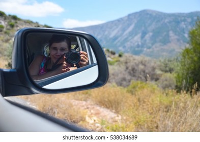 Pretty Girl Making A Self-portrait In Car Mirror (selfie)