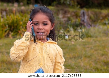 pretty girl outdoors with her mobile in hand,cell phone,nature,lifestyle,