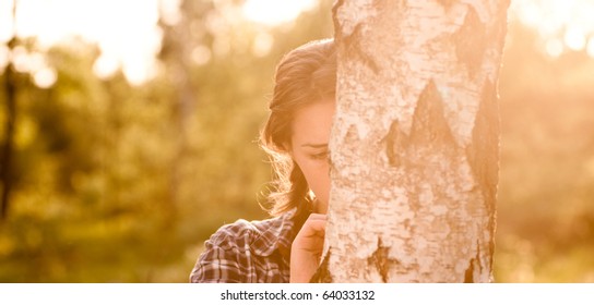Pretty girl in the park with sunrise - Shutterstock ID 64033132